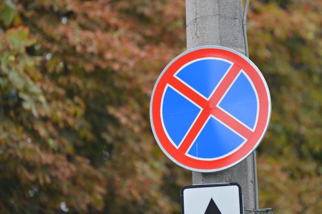 Sign with red circle and X over a blue circle